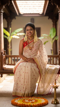 White and red linen saree with thread embroidery and gold zari border