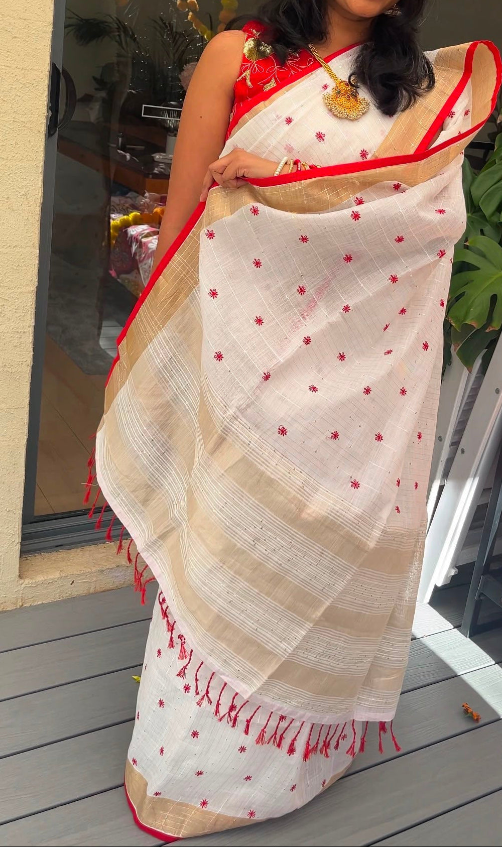 White and red linen saree with thread embroidery and gold zari border