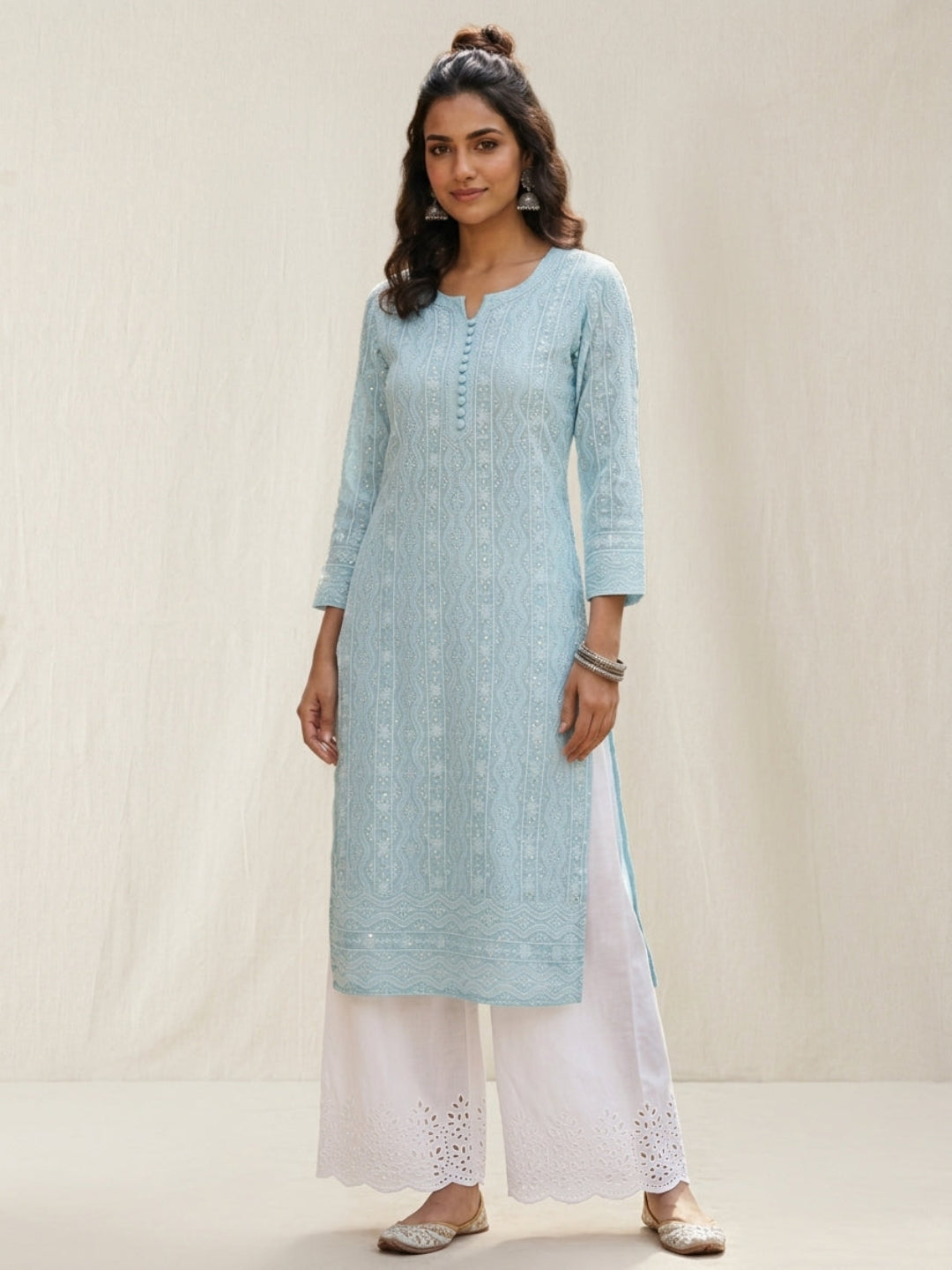 White cotton palazzo pants with scalloped floral embroidered hem, flat lay