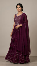 Woman in a wine purple floor-length anarkali suit with silver sequin bodice and matching embroidered dupatta